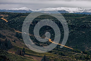 Scenic view of a winding road cutting through a rugged mountain landscape