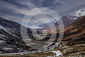 Scenic view of a winding road running along a valley in the Scottish Highlands