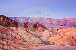 Scenic view from Zabriskie Point, showing convolutions, color contrasts, and texture in the eroded rock at dawn, Amargosa Range, photo