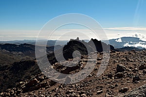 Scenic volcanic rock formations above the clouds at Mount Kenya