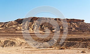 Scenic weathered yellow hill in stone desert