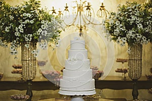 Scenic wedding cake with table bottom decorated with Brazilian flowers and sweets