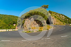 Scenic winding road bend in Anaga mountain range anainst bright blue sky Tenerife, Spain.