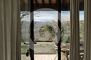 Scenic window view on a rural farmhouse terrace in Tuscany