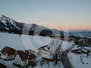 Scenic winter landscape featuring a ski slope dotted with cozy ski lodges