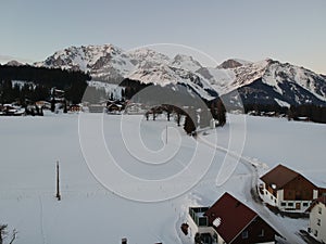 Scenic winter landscape featuring a ski slope dotted with cozy ski lodges