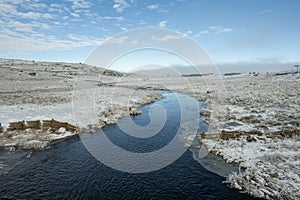 Scenic winter landscape with the Le Bes River. Aubrac, France