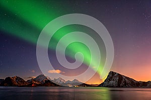 Scenic winter landscape with northern lights, Aurora borealis in night sky, Lofoten Islands, Norway