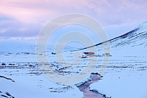 Scenic winter landscape with solitary farmhouses in the twilight, northern Iceland