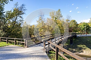 Scenic wooden bridge over a narrow lake connection in Bundek city park, Zagreb, Croatia