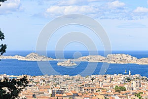 A scenics aerial view of the city of Marseille, bouches-du-rhone, France with rocky island in the background at the port under a