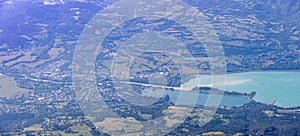 A scenics aerial view from the mountain of the of Embrun, hautes-alpes, France town and valley with beautiful lake