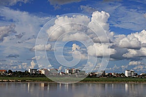 Scenics of the city along the Mekong river against cloudy sky.