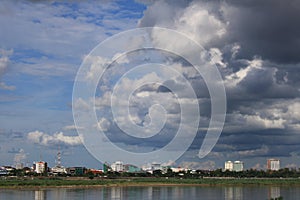 Scenics of the city along the Mekong river against cloudy sky.