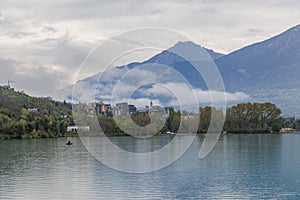 A scenics view of Embrun, Hautes-alpes, France old town with low white cloud with the lake (plan d\'eau)