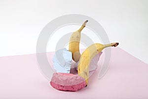 a scenographic composition of a still life composed of ripe bananas and brightly painted pebbles