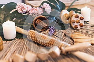 Scented candles and a set of wooden tools for massage