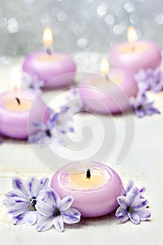 Scented candles and violet hyacinth flowers