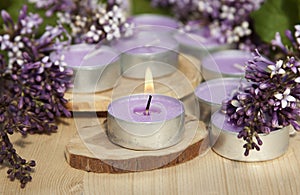 Scented candles on a wooden stand