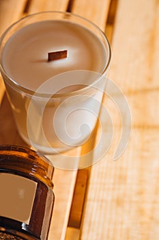 Scented candles on a wooden table.