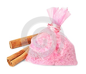 Scented sachet with aroma beads and cinnamon on white background