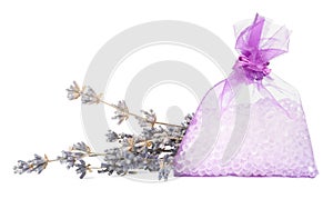 Scented sachet with aroma beads and dried lavender on white background