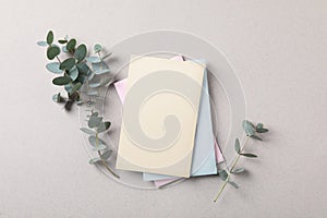 Scented sachets and eucalyptus branches on grey table, flat lay