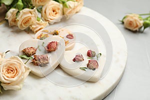 Scented sachets and flowers on light grey table