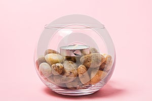 Scented tea candle in a glass jar with stones.