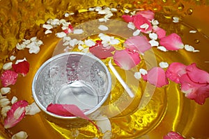 Scented water, flowers and silver bowl. Songkran festival Thailand.