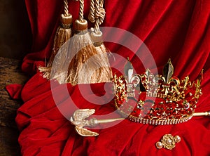 Scepter and crown on red velvet photo