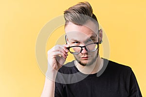 Sceptic judgy emotional millennial guy portrait