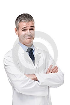 Sceptical doctor smiling at camera with cynicism