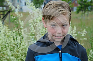 Sceptical looking teenage boy with blond hair