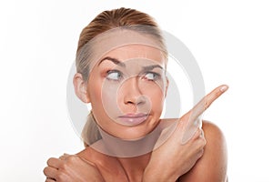 Sceptical woman pointing with her finger