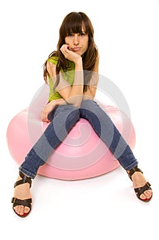 Sceptical woman sitting on chair photo