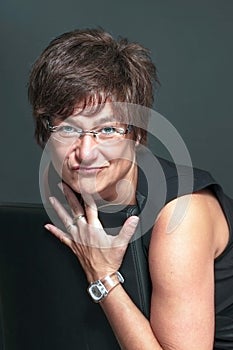 Scepticall,funny mature woman on grey background