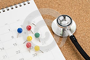 Schedule or appointment to meet the doctor for medical and health check up concept, stethoscope with colorful thumbtack or pushpin