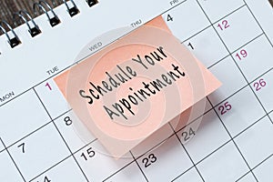 Schedule your appointment text on orange paper sticky note.