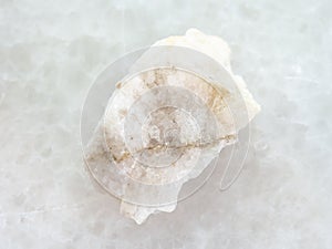 scheelite (tungsten ore) in raw stone on white