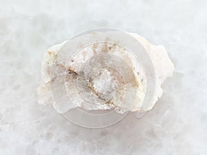 scheelite (tungsten ore) in rough stone on white
