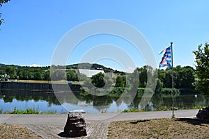 Schengen, Luxembourg - 07 11 2023: Moselle shore with the flag of Luxembourg