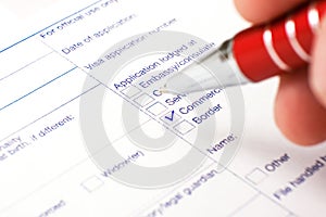 Schengen visa, questionnaire. Hand with pen completing a questionary