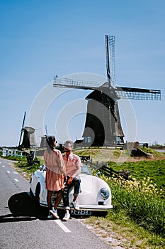 Schermerhorn Alkmaar Netherlands April 2020,. couple doing a road trip with a old vintage sport car White Porsche 356 Speedster,