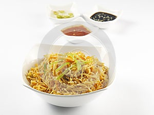 schezwan noodles in a bowl with vinegar and sauce