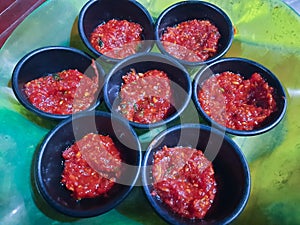 Schezwan Sauce / Szechuan chutney is an important ingredient in Chinese recipe. served in a bowl, isolated. selective focus