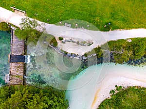 Schiederweiher in Hinterstoder top bottom drone aerial view to small dam and flowing water