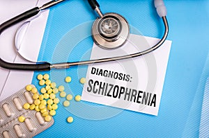 Schizophrenia word written on medical blue folder