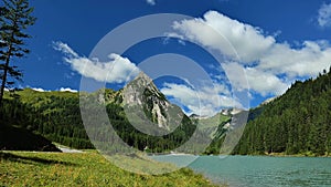 Schlierersee Mountain lake .Lungau Austria. green water of lake on mountain landscape and blue sky with clouds