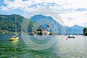 Schloss Ort castle near Traunsee, Austria. View of ancient castle with long bridge over lake. Famous tourist destination